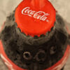 The Top of a Coco Cola Bottle in Red
