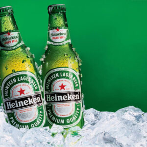Two Heineken Beer Bottles in Green on Ice